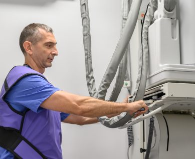 A radiologist operating the X-Ray