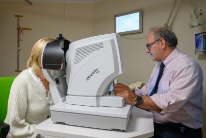 A consultant tests a patient's vision