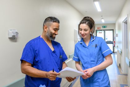 Nurses in discussion over a file