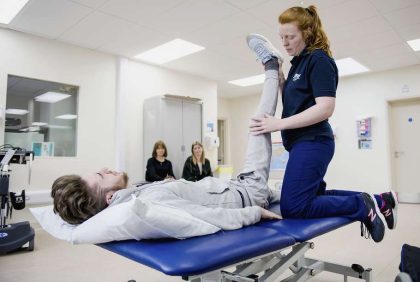 Physio with patient on treatment couch