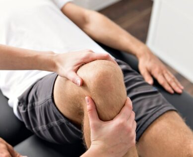 Physiotherapist massaging patients knee to loosen joint