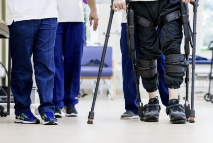 Patient using exoskeleton to assist leg movement
