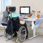 Wheelchair user at computer therapy console