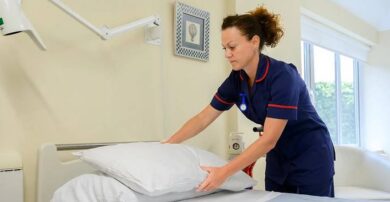 Nurse making bed in private room