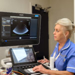 nurse operating ultrasound machine