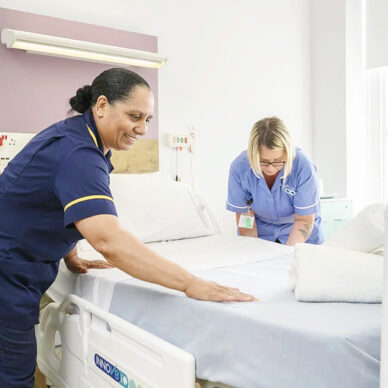 Nursing staff making bed